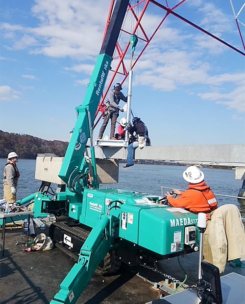 MAEDA Mini Crane lifting on a barge to work on TVA towers in Tennessee 