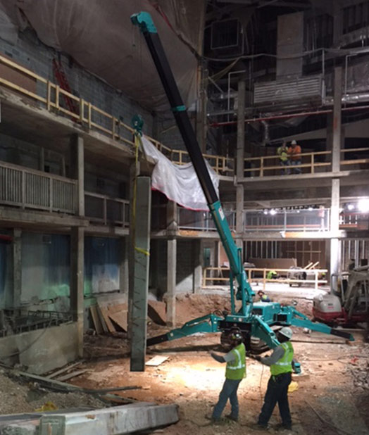 MAEDA Mini Crane lifting material inside construction of Georgia Aquarium 