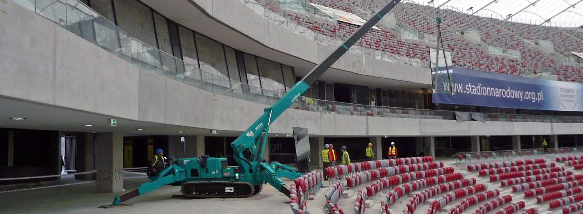 MAEDA Mini Crane MC405C lifting glass pane for glazing work in stadium