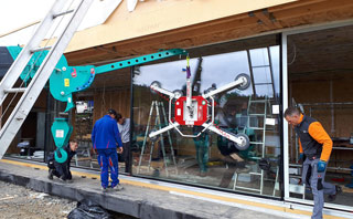MAEDA Mini Crane using vacuum glass handlers for glazing works